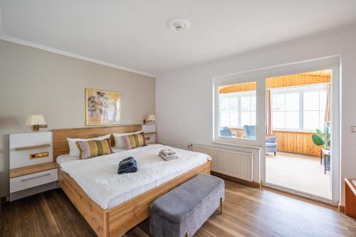 a bedroom with a large bed and a chair at Pension Villa Seefrieden in Binz
