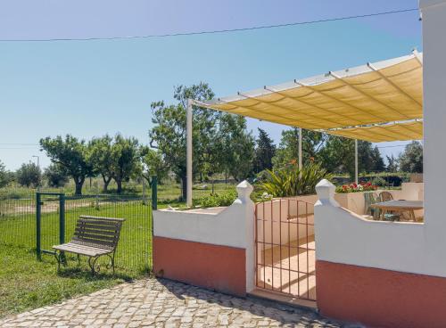 a patio with a chair and a fence and a table at Quinta da Foz - Vivenda Amélia in Foz