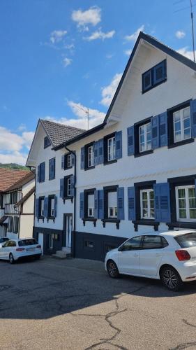 a white car parked in front of a building at Ferienhaus Bühlertal mit 3 Fewos in Bühlertal