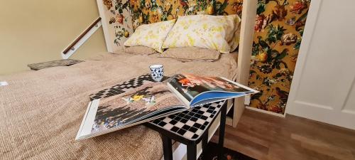 a bedroom with a bed with a book on a table at Studio Nieuwland in Alkmaar