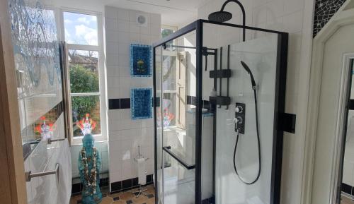 a shower with a glass door in a bathroom at Studio Nieuwland in Alkmaar