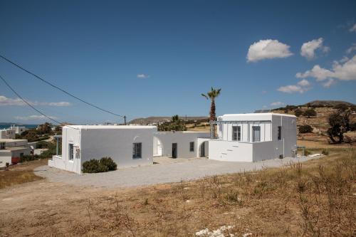 a white house in the middle of a field at Soley Naxos in Naxos Chora