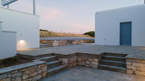 a stone patio with stairs and a door at Soley Naxos in Naxos Chora