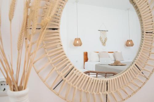 a mirror reflecting a bedroom with a bed at Soley Naxos in Naxos Chora