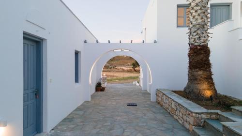 an archway in a white building with a tree at Soley Naxos in Naxos Chora