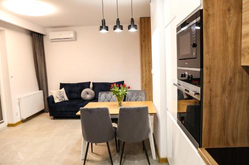 a living room with a table and a couch at Apartament Królowej Jadwigi z garażem in Radom