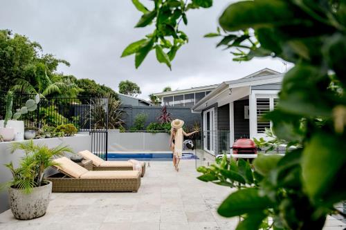 a woman in a dress walking on a patio at Blue Horizon in Mollymook