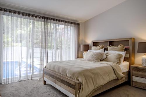 a bedroom with a large bed and a large window at Blue Horizon in Mollymook