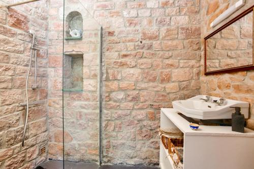 une salle de bain avec un lavabo et une douche en verre dans l'établissement Belle demeure de pierre au calme à Erquy, à Erquy