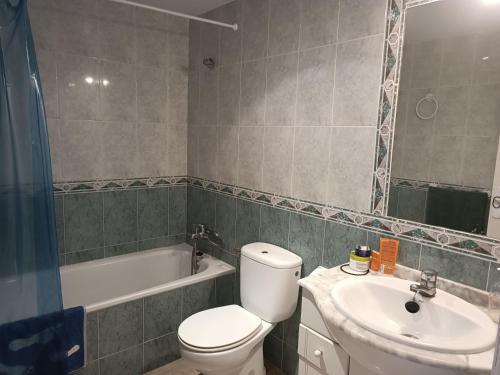 a bathroom with a toilet and a sink and a tub at Vera Natura Apartamento Angela in Playas de Vera