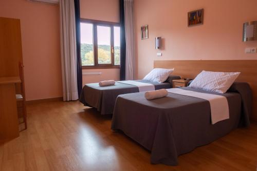 zwei Betten in einem Zimmer mit Fenster in der Unterkunft HOTEL EL MOLINO DE PANCORBO in Pancorbo
