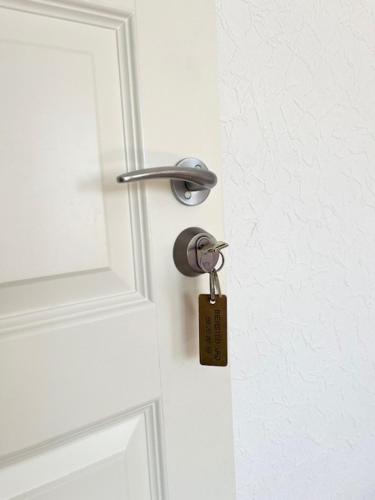 a lock on a door with a key at Biersted Kro in Åbybro