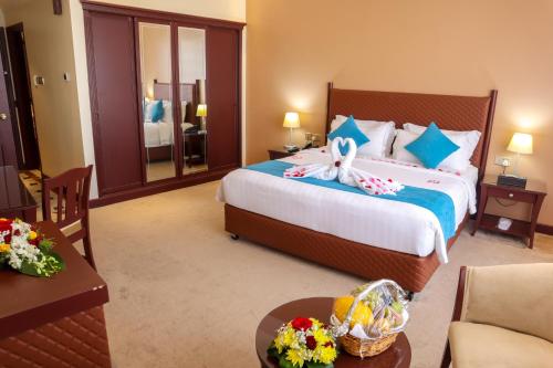 a hotel room with a bed with a bunny on it at Happy Days Hotel in Manama