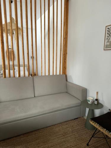 a couch in a living room with a table at Kalnterimi Guest House Skyros in Skiros
