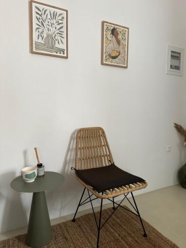 a chair and a table in a room at Kalnterimi Guest House Skyros in Skiros