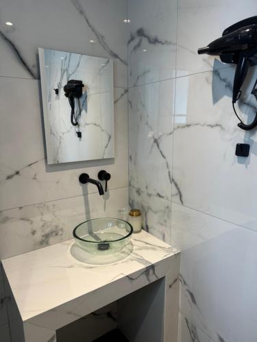 a bathroom with a glass sink and a shower at Kalnterimi Guest House Skyros in Skiros