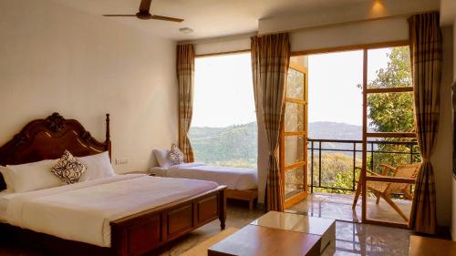 a bedroom with a bed and a large window at MERIDIAN HILL TOP YERCAUD in Yercaud