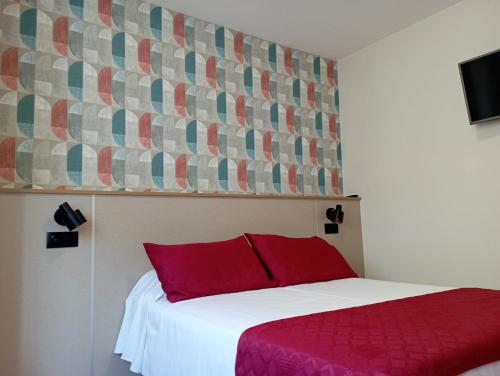 a bedroom with a bed with a red pillow at Apartamentos VIDA Sanxenxo in Sanxenxo