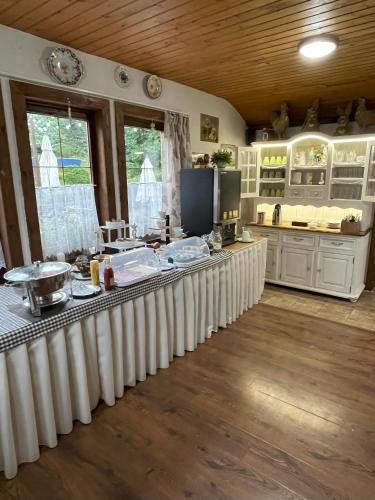 a kitchen with white cabinets and a counter top at Penzión Pod Guglom in Mlynky 