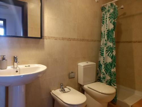 a bathroom with a sink and a toilet and a mirror at Townhouse Altea Hills in Altea