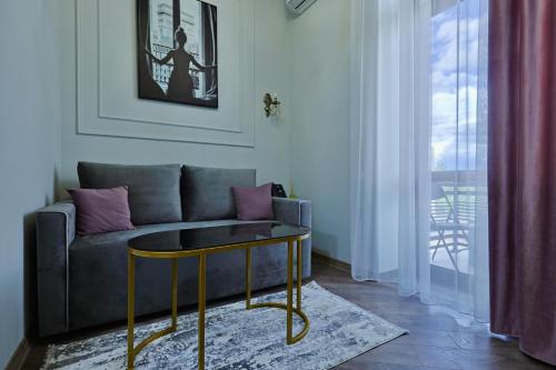 a living room with a couch and a table at Fiorella Gyumri in Gyumri