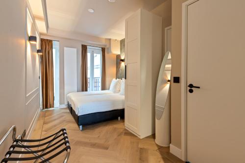 a hotel room with a bed and a window at Midtown Hotel Triple Room in Amsterdam