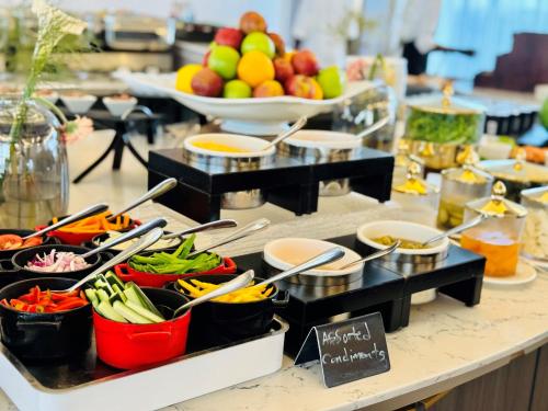 a buffet of food with bowls of fruits and vegetables at InterContinental Lusaka, an IHG Hotel in Lusaka