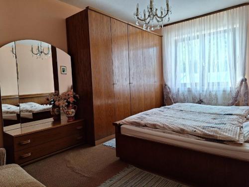 a bedroom with a large bed and a large mirror at Ferienwohnung Marianne Simon in Tann