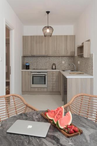 a kitchen with a table with a plate of fruit on it at Soley Naxos in Naxos Chora