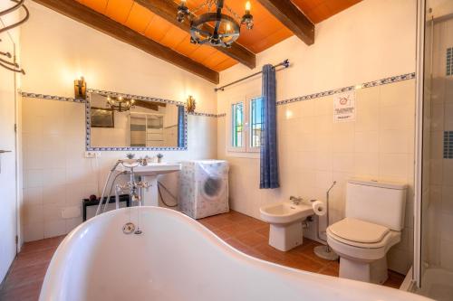 a bathroom with a tub and a toilet at Finca JESUS Pollensa in Port de Pollensa