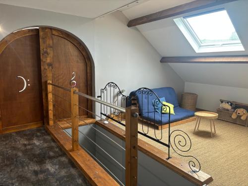 an attic room with a bunk bed and a window at gîte coeur de champagne in Romery
