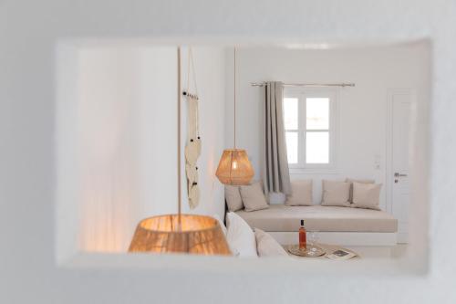 a white living room with a couch and a table at Soley Naxos in Naxos Chora