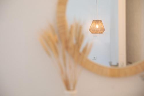 a reflection of a mirror with a lamp and a light at Soley Naxos in Naxos Chora