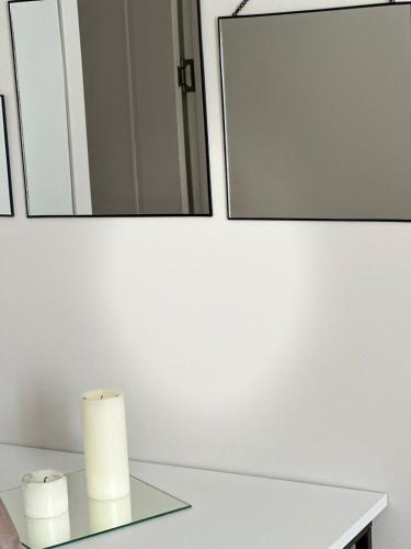 a bathroom with two rolls of toilet paper and a mirror at LARDA TBILISI in Tbilisi City