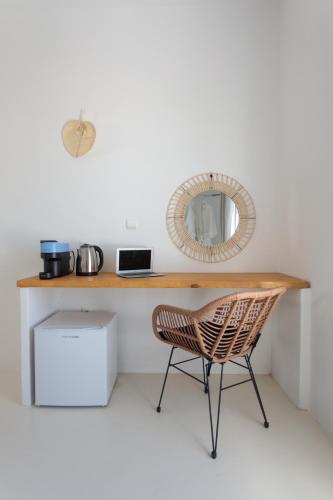 a desk with a chair and a mirror at Soley Naxos in Naxos Chora
