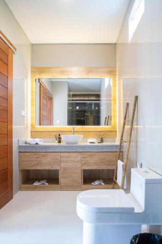 a bathroom with a sink and a mirror at Sundaze 2 - Canggu Paradise with Pool and Kitchen Brand NEW in Kerobokan