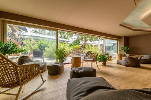 a large living room with a large glass window at Hotel Alpensonne in Bad Wiessee