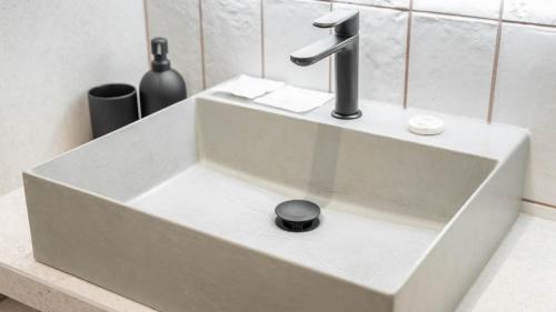 a white sink with a faucet in a bathroom at Amatera Luxury Apartments in Matera