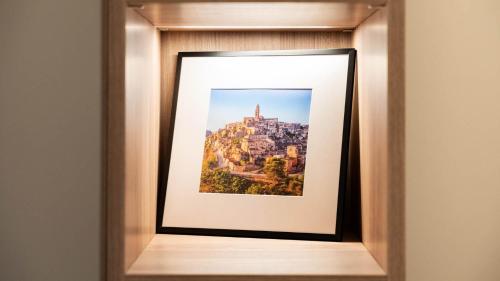 a picture frame with a picture of a city at Amatera Luxury Apartments in Matera