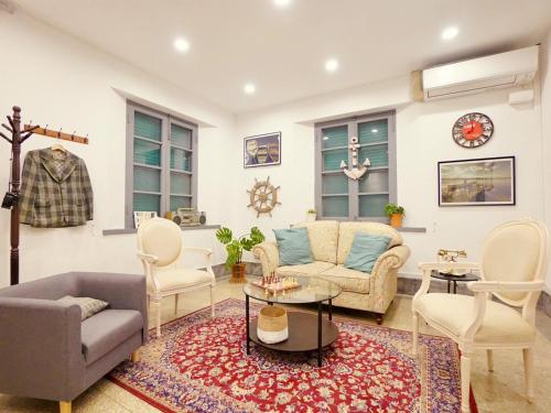 a living room with a couch and chairs at Gaomei Lighthouse in Taichung