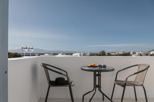 a table and two chairs on a balcony with a view at Soley Naxos in Naxos Chora