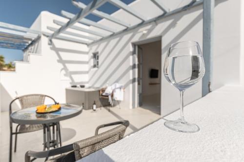 a wine glass sitting on a table on a balcony at Soley Naxos in Naxos Chora