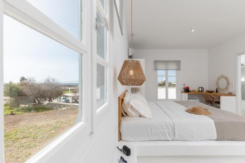a bedroom with a bed and a large window at Soley Naxos in Naxos Chora