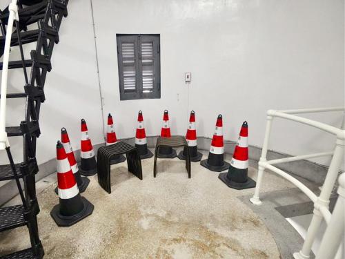 a group of red and white cones sitting in a room at Gaomei Lighthouse in Taichung