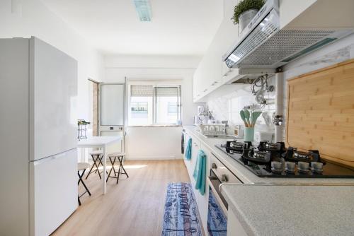 a kitchen with white counters and a stove top oven at Casandrade 148 - Lisbon South Bay in Cabeço de Alhos Vedros