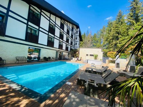 a swimming pool in front of a building at Elexus Predeal in Predeal