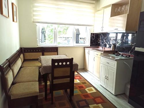 a small kitchen with a table and a window at NEXT TO CAFES, BEACH AND ALL AMENITIES in Antalya