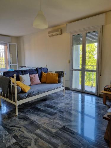 ein Wohnzimmer mit einem blauen Sofa und bunten Kissen in der Unterkunft Attico vista San Luca in Bologna
