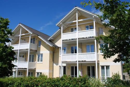 a large apartment building with white balconies at Wohnpark Stadt Hamburg - Apt. 14 in Binz