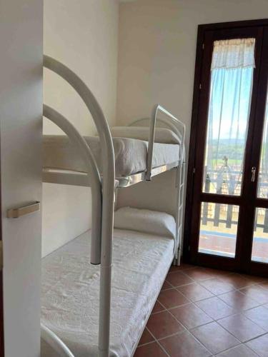 a group of bunk beds in a room with a window at Casa nuova indipendente in Sardegna in Laerru